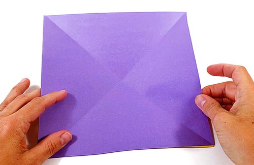 Paper square with two diagonal creases. 