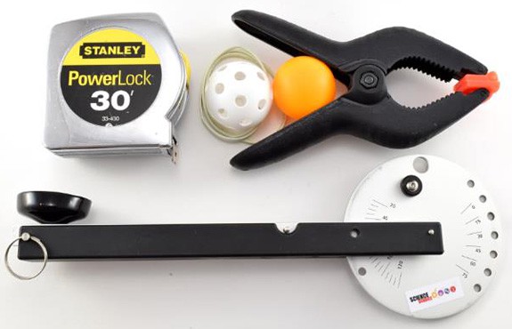 A tape measure, whiffle ball, ping pong ball, squeeze clamp and catapult base and disc