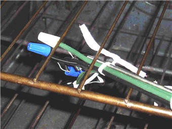 Various wires and sensors are secured to a metal rack