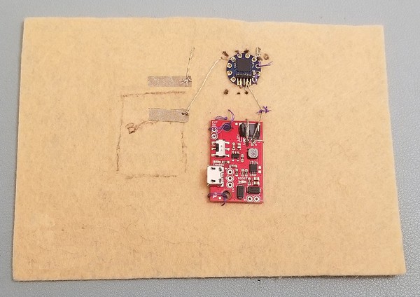 Conductive fabric tape patches for pins A0 and 3 on TInyLily. 