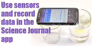 A smartphone with the Google Science Journal app opened lays across the rims of two cups