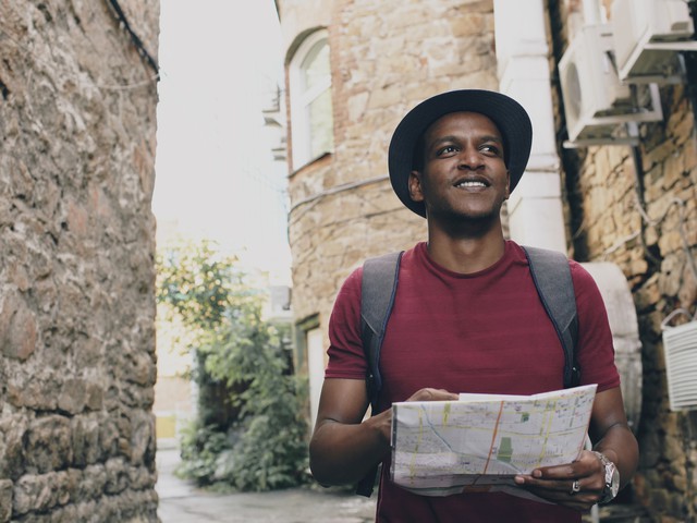 man in city with map