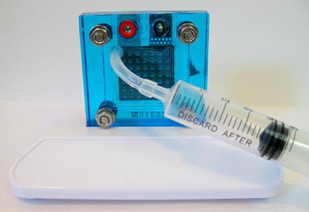 Plastic syringe attached to a reversible hydrogen fuel cell with a plastic tube