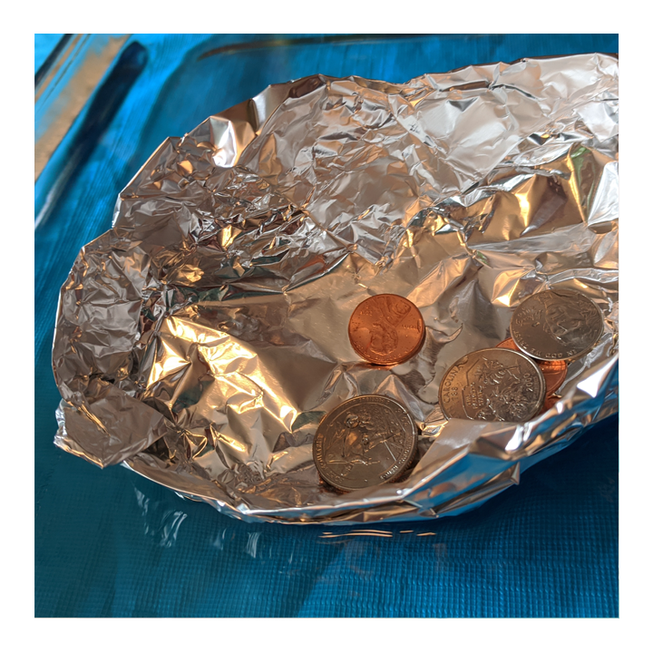 Aluminum foil boat with pennies inside - Awesome Summer Science Experiments