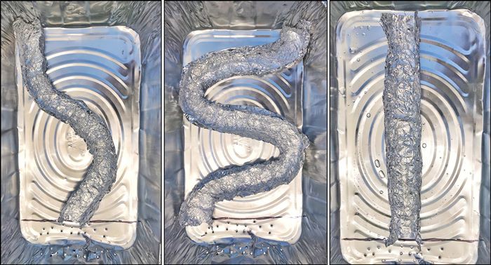 Three aluminum pans with a straight, a curved and a slightly bent aluminum foil river model.