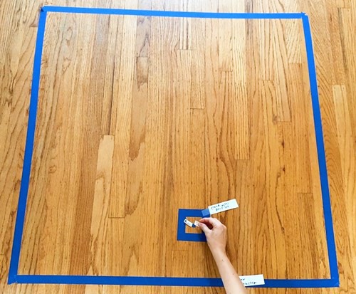 Several squares of different sizes marked with masking tape on the floor.