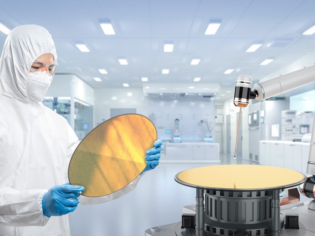 technician holding semiconductor wafer