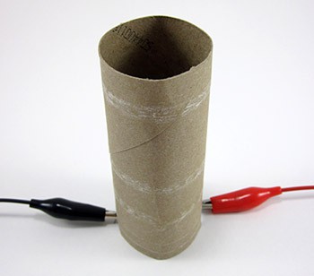 Paper tube placed over a lightbulb with the cables passing through pre-cut notches
