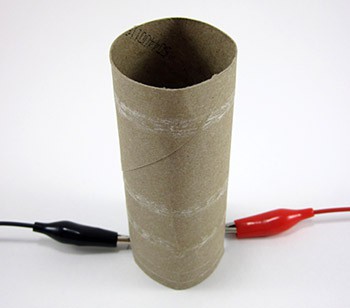 Paper tube placed over a lightbulb with the cables passing through pre-cut notches