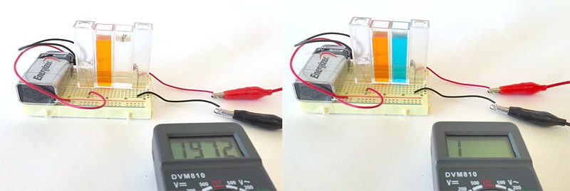 Spectrophotometer setup with cuvettes, multimeter, and 9-volt battery