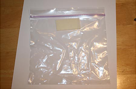 A piece of tape is placed on the side of a plastic zip top bag