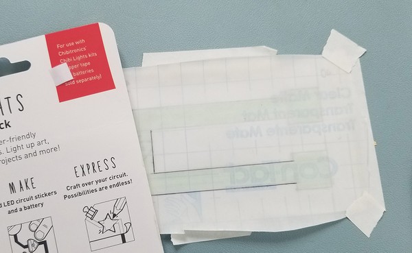 Using a straight edge to draw the outline of the template shape. 