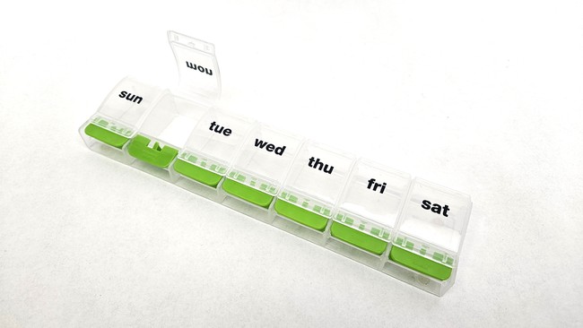 A plastic pill dispenser with one compartment for each day of the week.