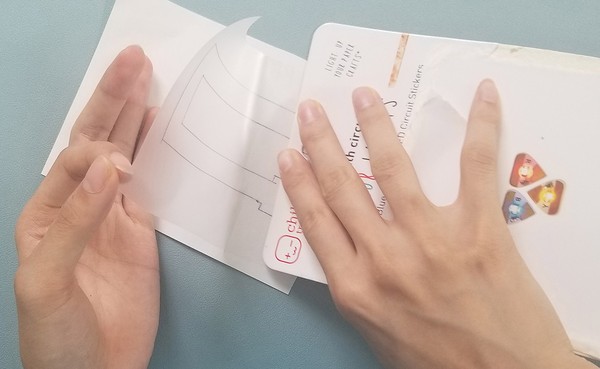 Smoothing out the vinyl with cardboard to prevent air bubble 