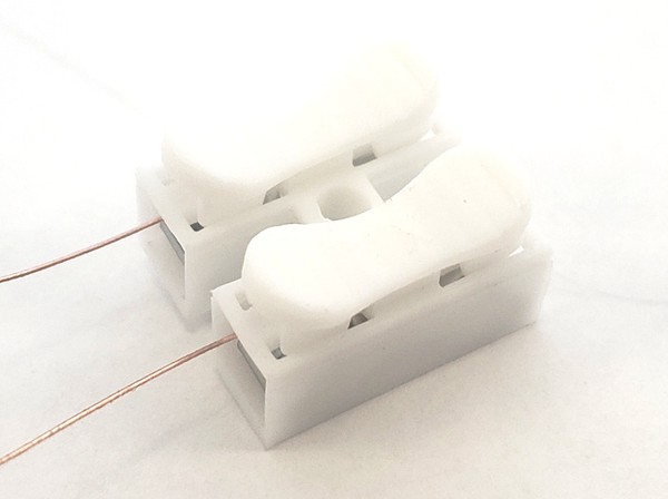 Magnet wire inserted into spring clips 
