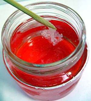 A glass jar filled with red gel