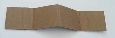 A rectangular sheet of cardboard is folded into the shape of a flattened W