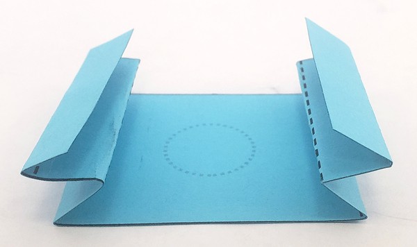Large rectangular template piece folded along dotted lines into accordion shape. 