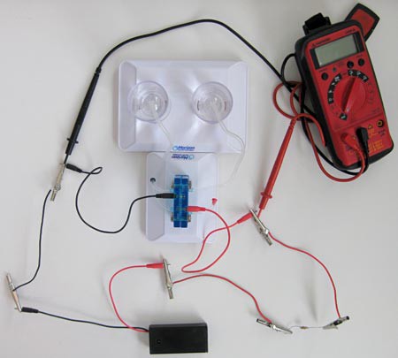 Probes of a multimeter measure voltage drop across a reversible fuel cell