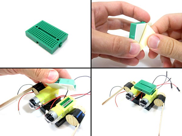 A mini breadboard is taped to two DC motors