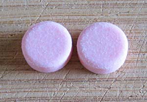 Two pink circular tablets