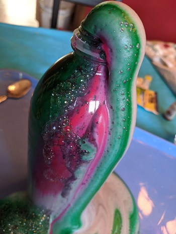 Foaming elephant toothpaste oozing out of a bottle 