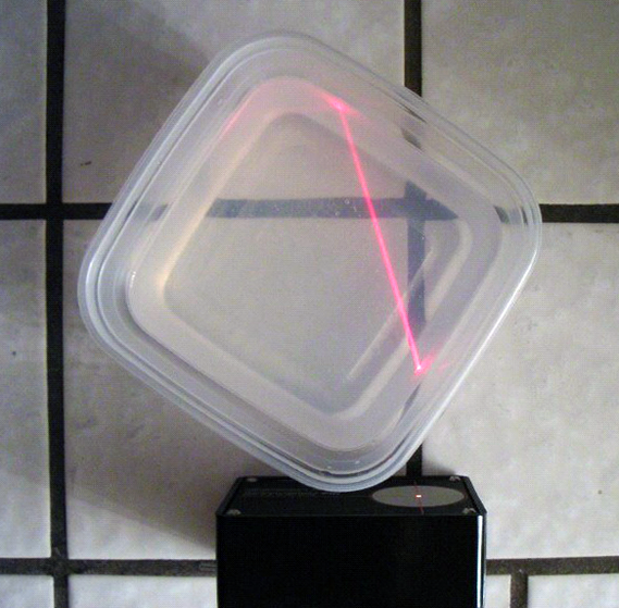 A plastic container with a laser beam passing through gelatin
