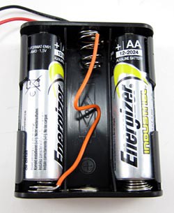 A jumper wire is used to convert a three double A battery pack into a two double A battery pack