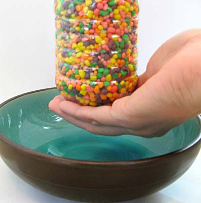 Bottle of Nerds candy held above a bowl