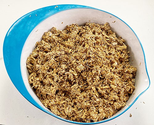  Organic material that looks like small wood chips in a bowl.  