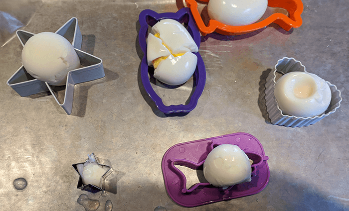 Hard-boiled eggs in a variety of shaped cookie cutters, like stars and hearts