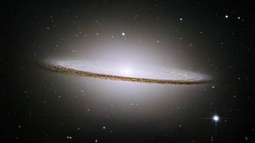 Photo of the Sombrero galaxy resembles a large ring with a bright white light at the center