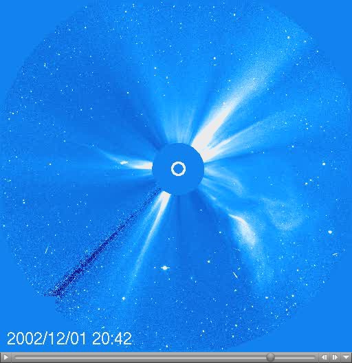 A coronagraph shows a large white flare emerging from the surface of the Sun with a timestamp of 2002/12/01 20:42