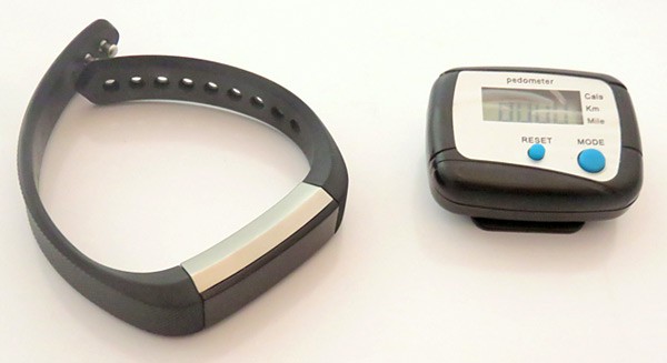 A watch style fitness tracker and a pedometer side-by-side