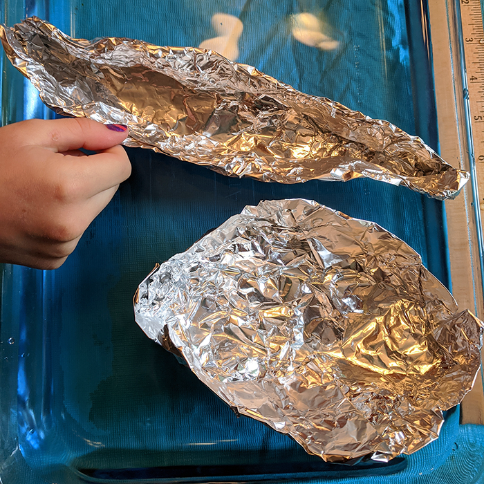 Two styles of aluminum foil boats side by side