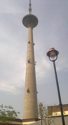 the Pitampura TV tower, a skinny cylindrical tower with a round deck at the top