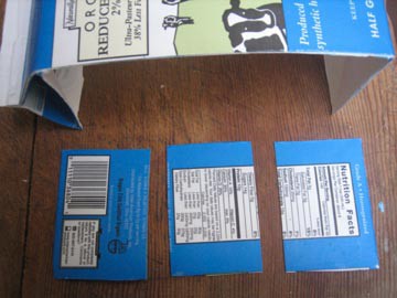 A side wall of a large milk carton is cut horizontally into three even pieces