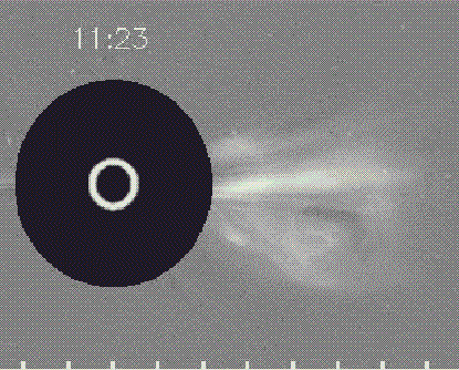 A coronagraph shows a large white flare dissipating from the surface of the Sun with a timestamp of 11:23