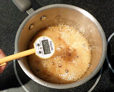 Maple syrup boiling in a saucepan at two-hundred and fifty degrees fahrenheit