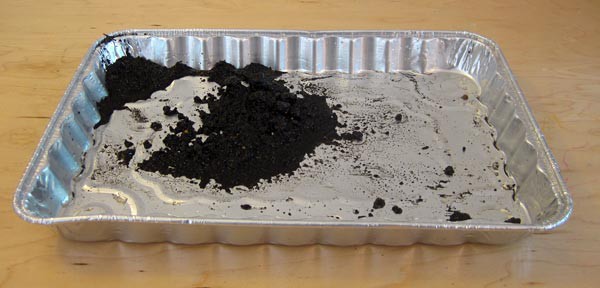 Soil collects in an aluminum baking tray