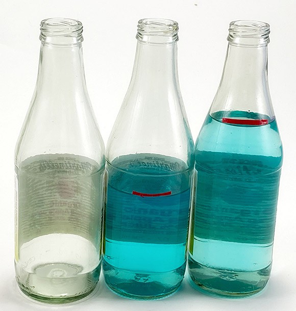 3 bottles with no, half, and mostly filled with colored water