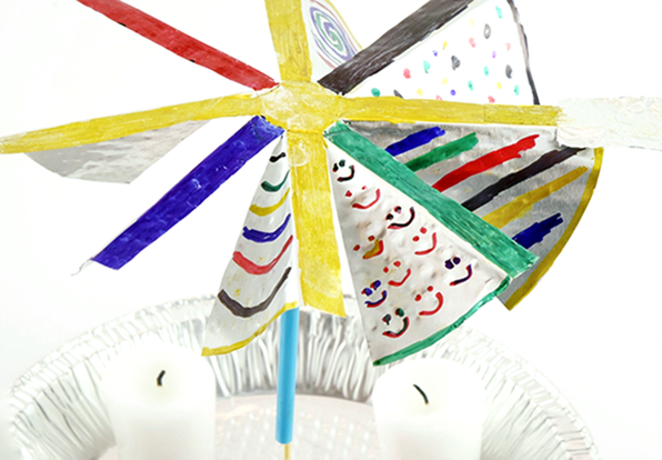 A candle carousel made from aluminum pie pans and candles