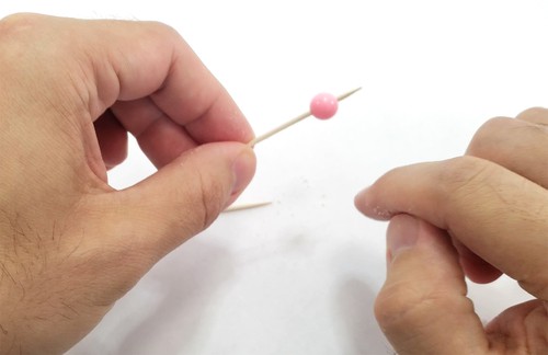 plastic bead on a toothpick 