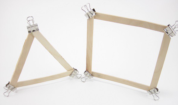 A triangle and square both made of popsicle sticks and held together with small binder clips