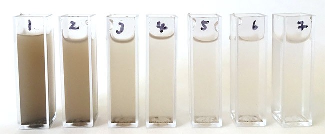 Seven cuvettes are filled with different solutions of water mixed with suspended solids