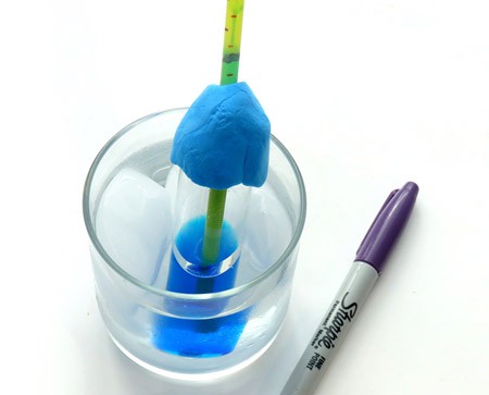 A homemade thermometer is placed in a glass of ice water