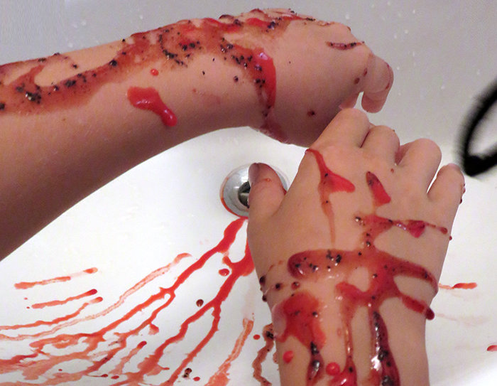 Hands covered in fake blood made with science activity