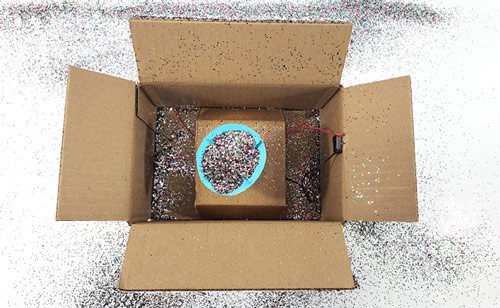 A glitter trap triggered when opening a box