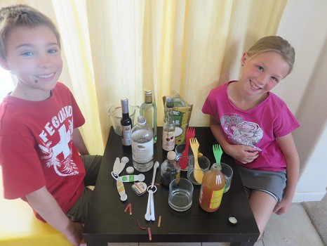 Two kids smiling in anticipation of starting their science project