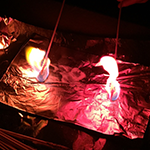 Image of two skewers coated with chemicals in a flame to explore the colors different chemicals burn